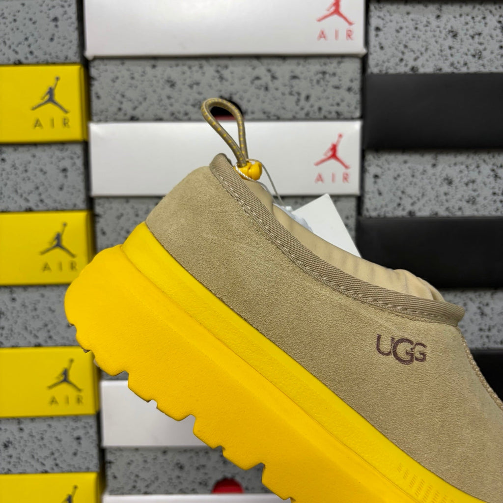 UGG Neumeel Deco Slip-On – Suede Moccasin Sneaker with Yellow Lug Sole & Carabiner Collar in Sand